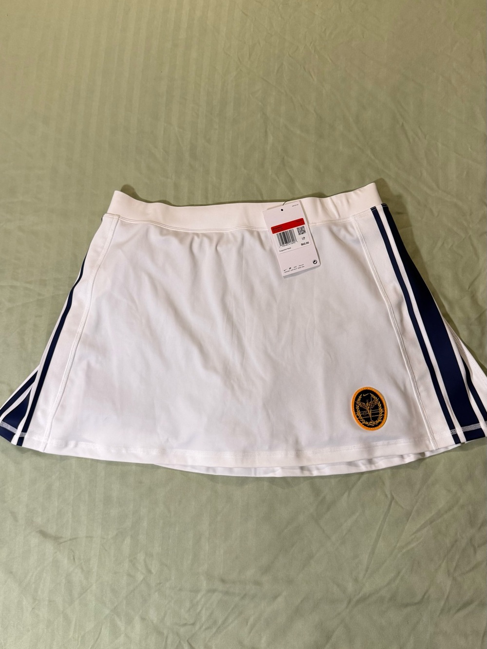 Nike White Tennis Skirt with Navy Side Stripes and Gold Crest